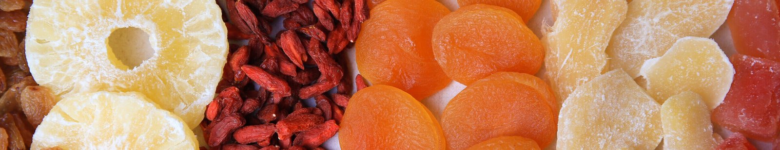 different tasty dried fruits as background, top view